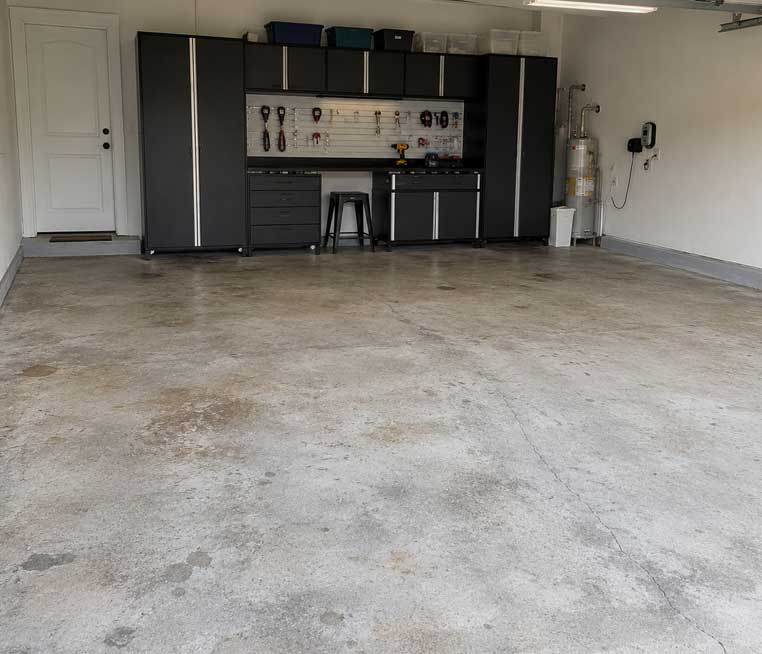 before-garage Damaged concrete floor before rubber resurfacing in Orlando