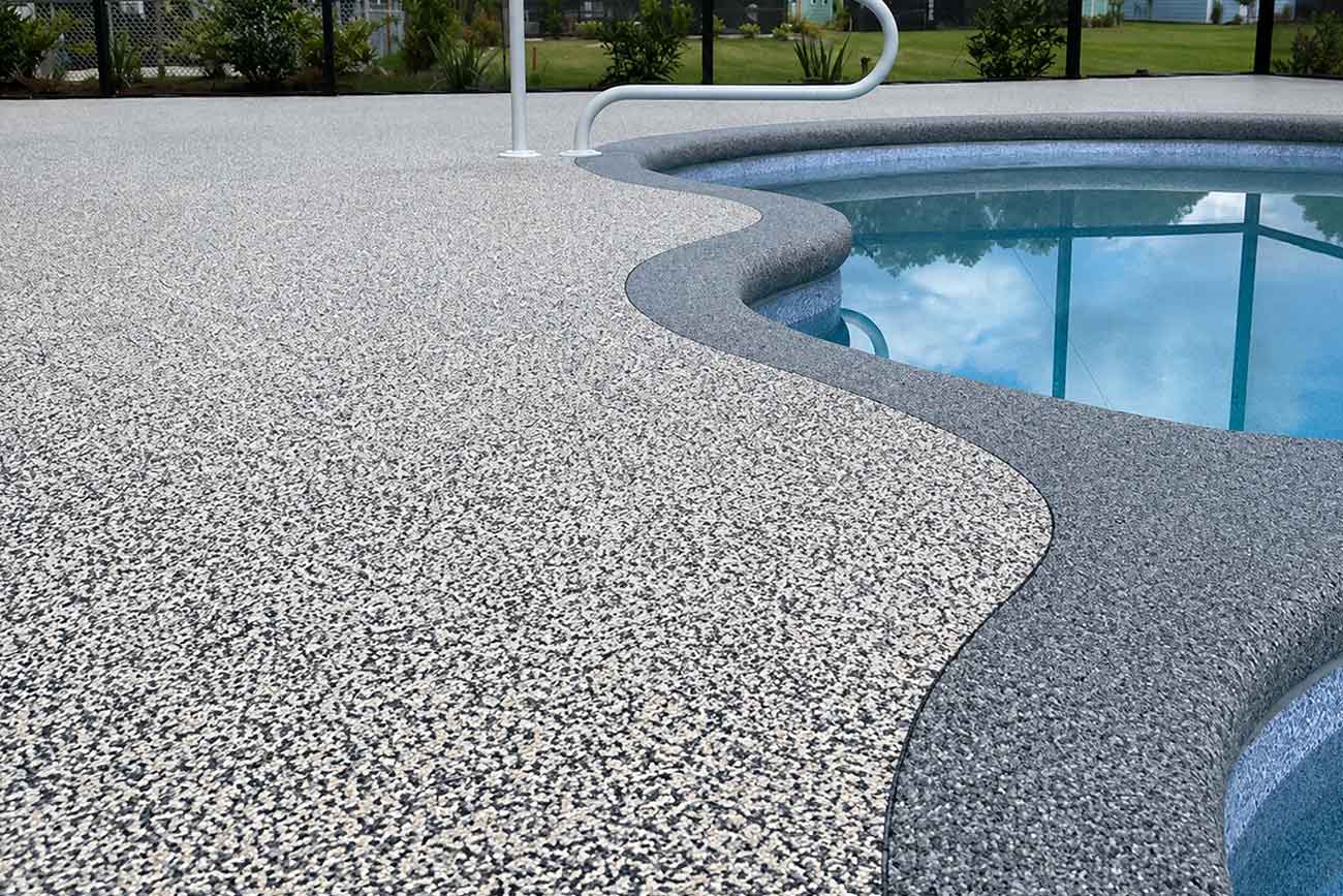 Custom-Vuba-Stone-pool-deck-featuring-decorative-borders-and-contrasting-resin-bound-stone-design Custom Vuba Stone pool deck featuring decorative borders and contrasting resin bound stone design