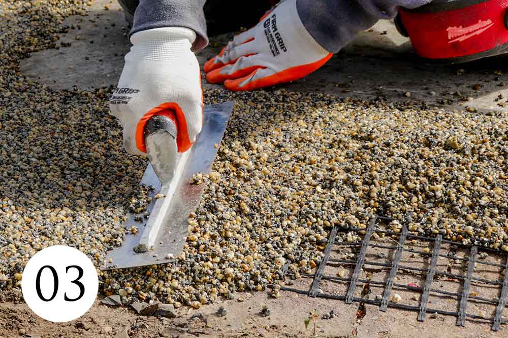 Hand-Troweling Professional installer hand troweling Vuba Stone resin bound surfacing for a seamless premium finish