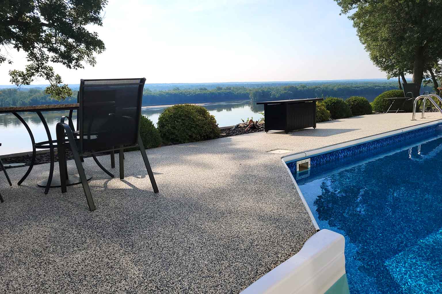 Residential-Spaces Premium Vuba Stone pool deck installation surrounding a luxury Florida swimming pool with seamless resin bound stone finish
