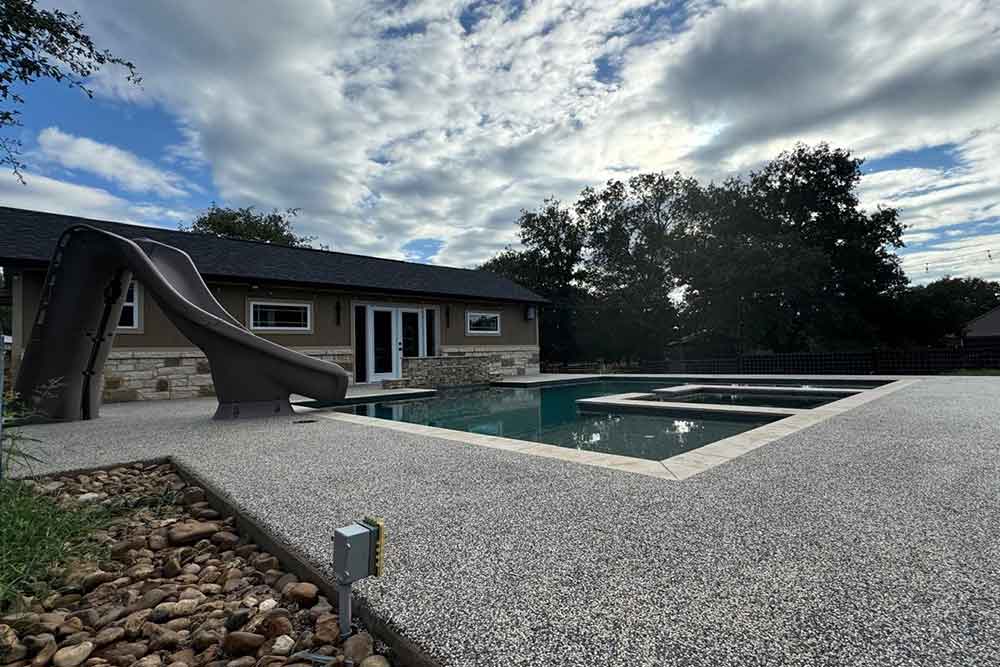 pool Premium Vuba Stone pool deck installation with seamless resin bound stone finish in a luxury Florida backyard